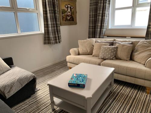 a living room with a couch and a coffee table at Portaferry Waterfront Townhouse with Hot Tub in Portaferry