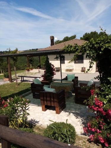 a house with a patio with furniture in the yard at Podere Battegone in Menestrello