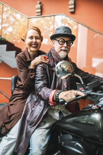 a man and woman sitting on a motorcycle at Hotel Gartner in Tirolo