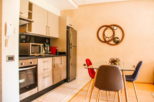 a kitchen with a table and chairs in a room at Bright Luxurious Apartment with Garden in Marrakesh