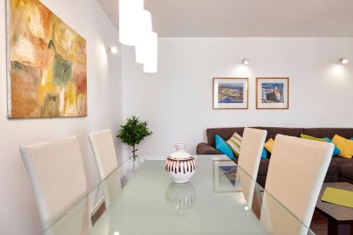 a dining room with a glass table and chairs at Apartments Gea Trogir in Trogir