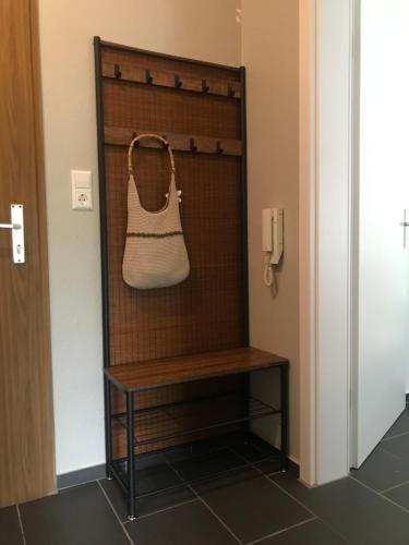 a purse hanging on a wall next to a bench at S-VILLA Apartments im Schwarzwald in Schiltach