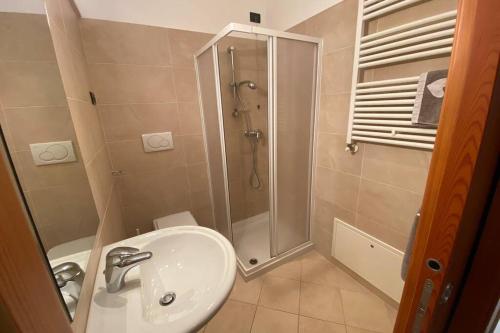 a bathroom with a sink and a shower at Mountain&Lake Apartment - CIPAT: 022104-AT-849776 in Levico Terme