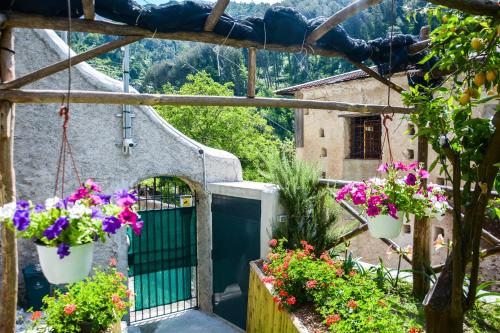 a balcony with flowers in white buckets at Holiday House Ruocco in Maiori