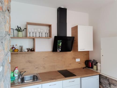 a kitchen with a sink and a counter top at Apartments Sandra in Lovran