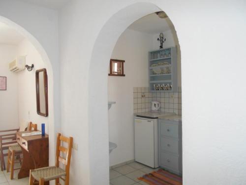 a kitchen with an archway and a table and chairs at PATMOS Mathios Studios- apartments in Patmos