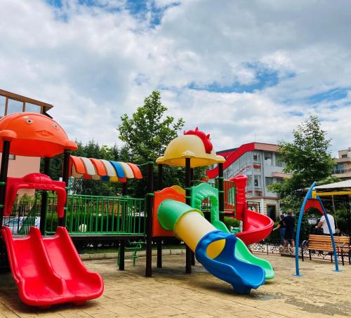 a playground with a slide and a slideintend at Good Vibes apartment Avalon in Sunny Beach