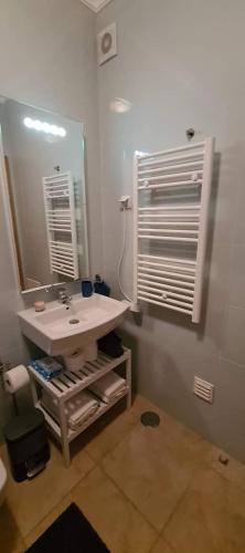 a bathroom with a sink and a mirror at LAGOS APARTMENT in Lagos
