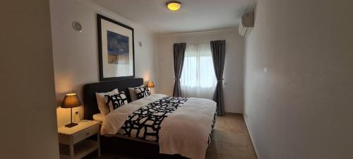 A bed or beds in a room at LAGOS APARTMENT