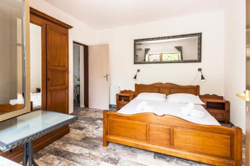 a bedroom with a bed and a glass table at Apartments & Rooms Strčić Petra in Krk