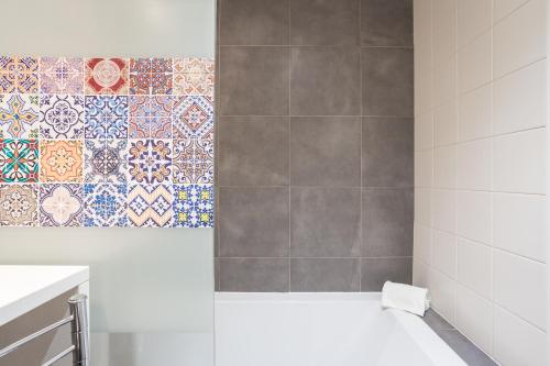 a bathroom with a shower with tiles on the wall at Vita Portucale ! Downtown Premium Apartment with Parking Garage in Lisbon