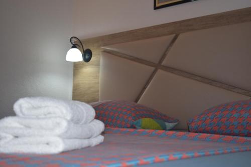 a pile of towels sitting on top of a bed at Guesthouse HHL - Liman ll in Ulcinj