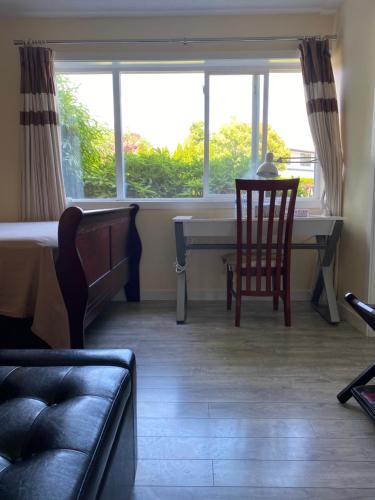 a room with a desk and a chair and a window at Richmond Vancouver Airport Comfy Home in Richmond