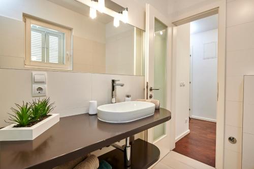 a bathroom with a sink and a mirror at Apartments Gea Trogir in Trogir