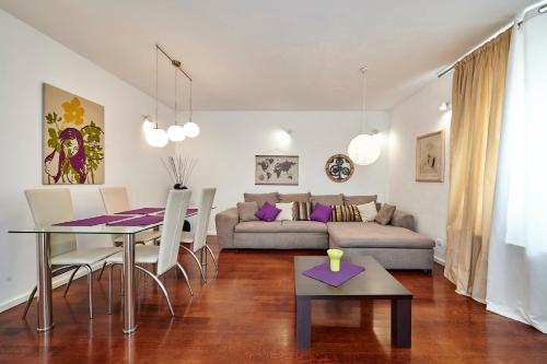 a living room with a table and a couch at Apartments Gea Trogir in Trogir