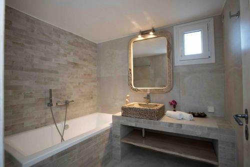 a bathroom with a sink and a mirror at Villa Jakie in Mýkonos City