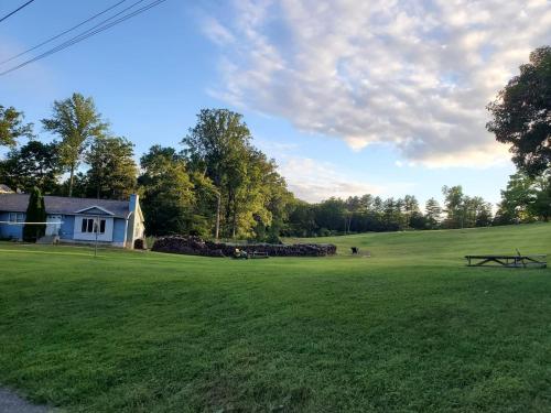 a large green field with a house and a building at Glenwood Inn - Stroudsburg in Delaware Water Gap