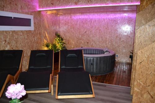a room with chairs and a round table and purple lighting at Casa do Outeiro in Arcos de Valdevez