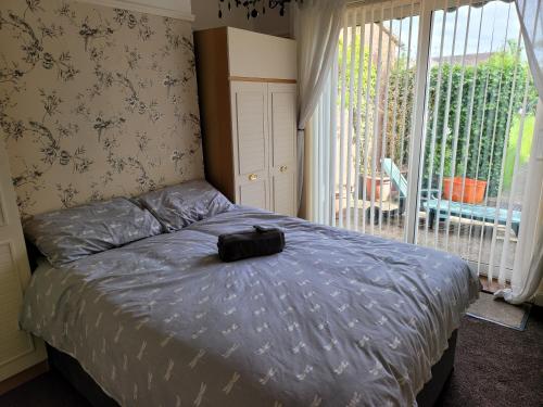 a bed with a black bag on it in a bedroom at Shergold Rooms in Swindon