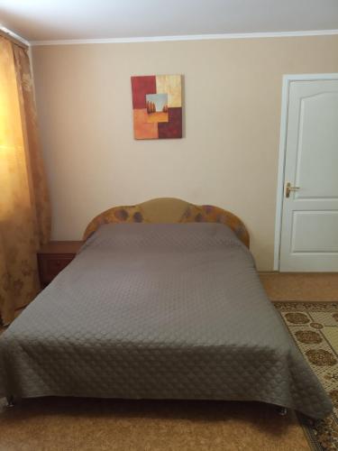 a bed in a bedroom with a painting on the wall at Комфортные апартаменты на приватной територии in Izmail
