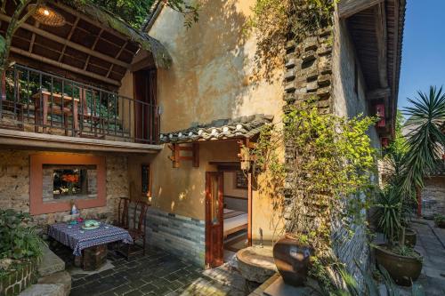 an outdoor patio with a table in a building at Yangshuo Secret Garden in Yangshuo