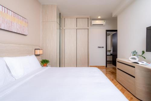 a bedroom with a large white bed in a room at Somerset Feliz Ho Chi Minh City in Ho Chi Minh City
