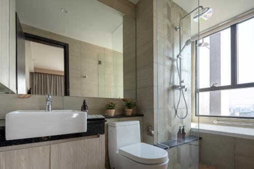 a bathroom with a toilet and a sink and a shower at Somerset Feliz Ho Chi Minh City in Ho Chi Minh City