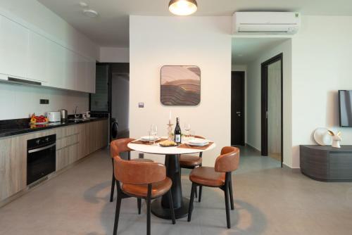 a kitchen and dining room with a table and chairs at Somerset Feliz Ho Chi Minh City in Ho Chi Minh City