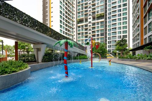 a pool with a palm tree and a water slide at Somerset Feliz Ho Chi Minh City in Ho Chi Minh City