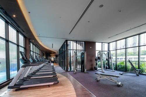 a gym with a row of treadmills and machines at Somerset Feliz Ho Chi Minh City in Ho Chi Minh City