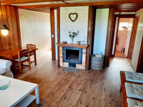 a living room with a fireplace and a table at Malovaný sklípek in Hlohovec