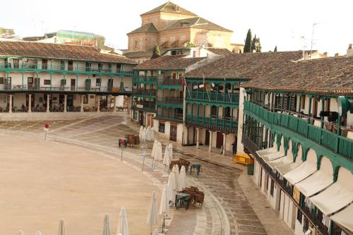an empty street in a town with many buildings at Los Balcones de Galaz in Chinchón