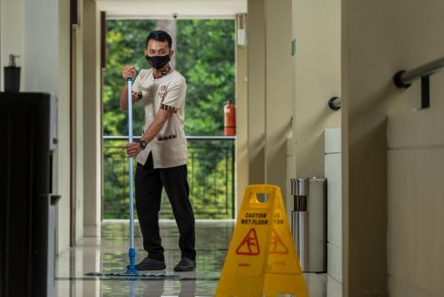 a man standing in a hallway with a mask on at Nava Hotel Tawangmangu in Tawangmangu