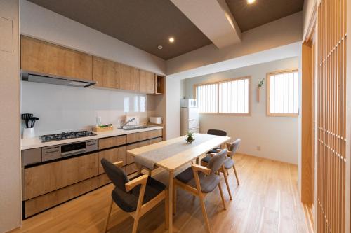 a kitchen and dining room with a table and chairs at 白樺の宿 恵美須, Shirakabanoyado EBISU, SELF CHECK-IN in Osaka