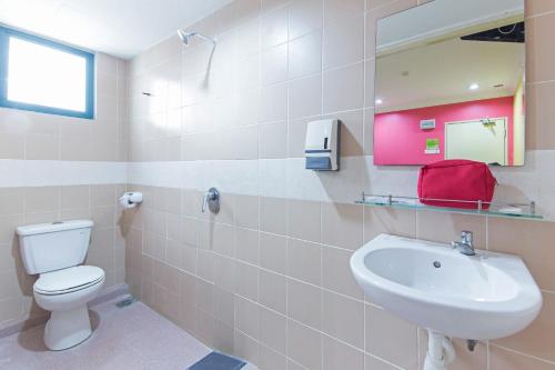 a bathroom with a white toilet and a sink at Hotel Sunjoy9 Bandar Sunway in Petaling Jaya