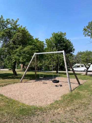 an empty swing set in a park at Rosenfors Vandrarhem in Borgholm