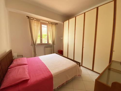 a bedroom with a large bed and a window at Villa a Lipari in Lipari