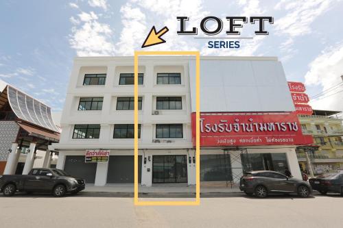 a white building with a sign on top of it at Loft Series by Pak-Up in Krabi town