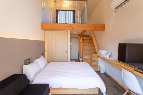 a small room with a bed and a television at B&B MIKAWA 5 - Villas with BBQ Terrace in Kanazawa