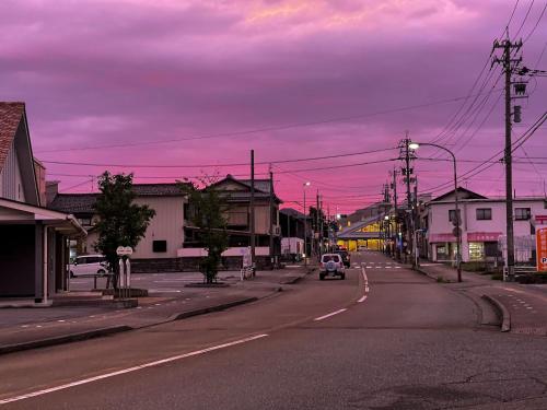 an empty city street with a car driving down the road at B&B MIKAWA 5 - Villas with BBQ Terrace in Kanazawa