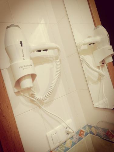 a room with a hair dryer and a phone on a wall at APARTAMENTO EN PUNTA UMBRÍA in Punta Umbría