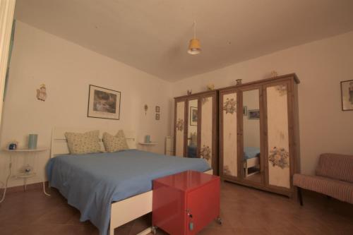 a bedroom with a bed and a red cabinet at Casa RoSiLù in Monopoli