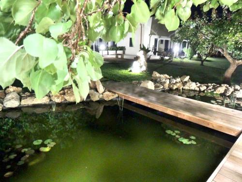 a wooden bridge over a pond in a yard at Giardino D'Oriente in Otranto