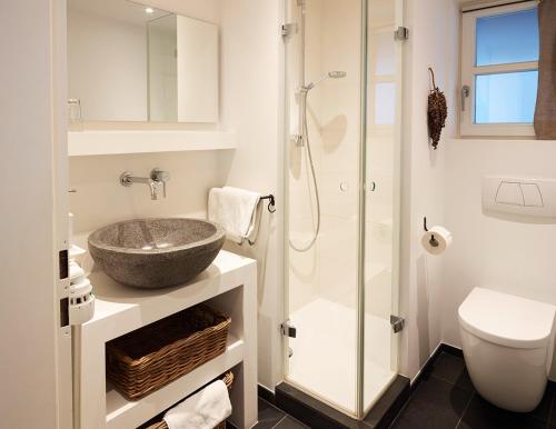 a bathroom with a sink and a shower at Haus Katrin in Bad Hindelang