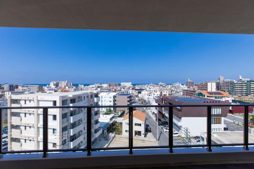 a view of a city from a balcony at Rizo Zaizen Hotel in Ginowan