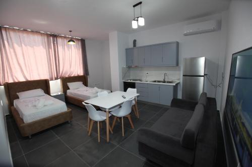 a room with a kitchen and a living room at Deda Apartments in Sarandë