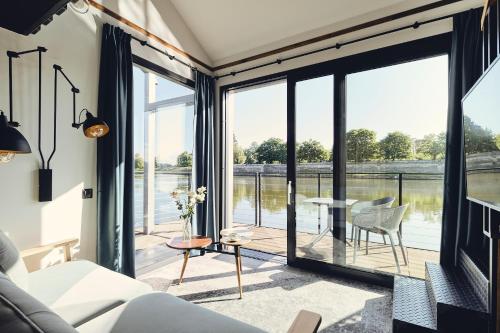 a living room with a view of the water at New Port Aparthotel in Kraków