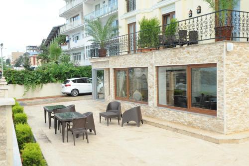a patio with tables and chairs in front of a building at Vurna Butik Hotel in Trabzon