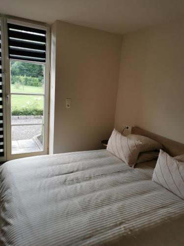a bedroom with a large bed with a window at La Majolique in Namur