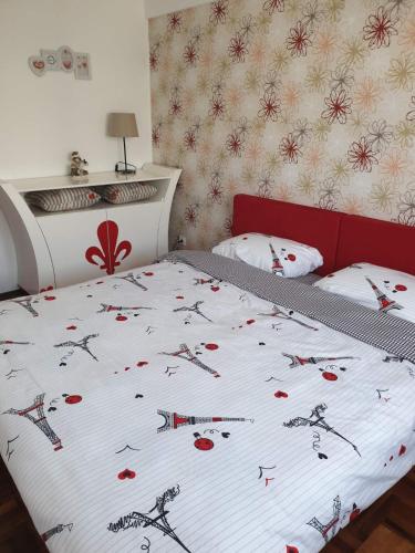 a bedroom with a bed with a bedspread with weapons on it at Lux Apartman Ristić 2 in Soko Banja